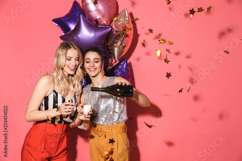 Photography Photo of two beautiful women 20s in stylish outfit holding festive balloons and