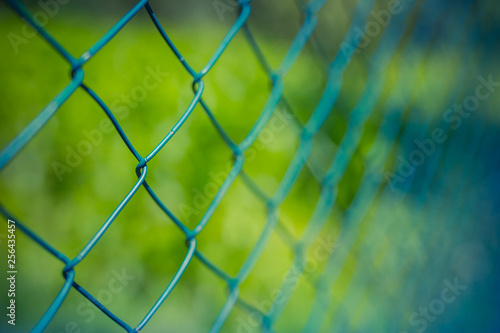 Steel fence with green background