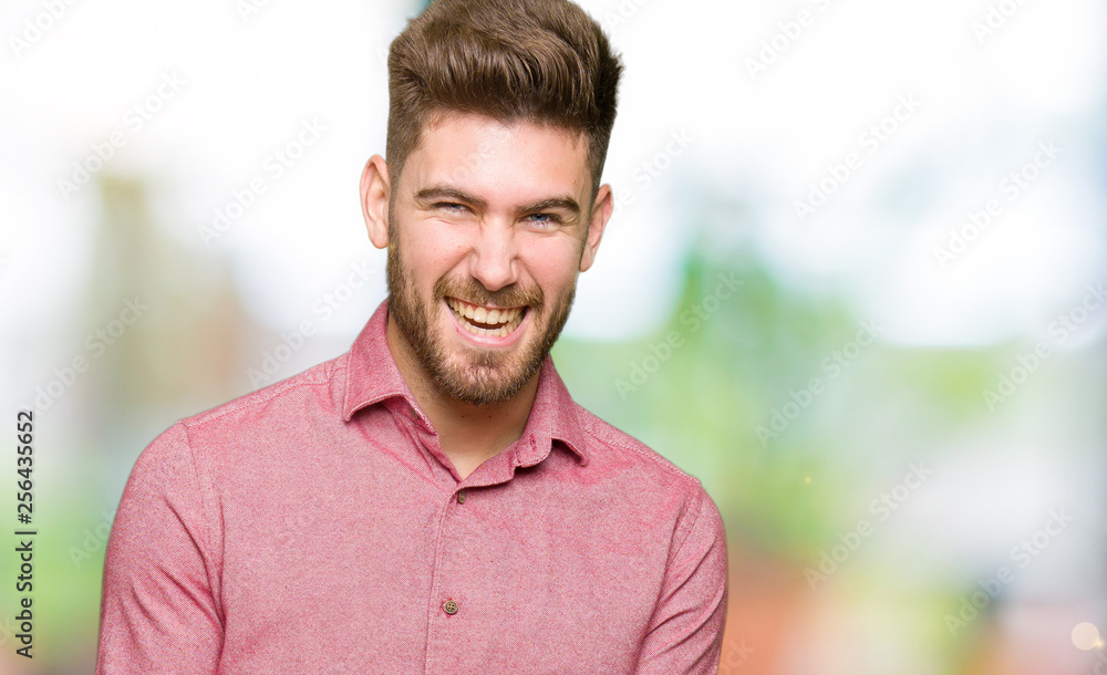 Young handsome business casual man very happy and excited doing winner gesture with arms raised, smiling and screaming for success. Celebration concept. Young handsome business casual man very happy and excited doing winner gesture with arms raised, smiling and screaming for success. Celebration concept.