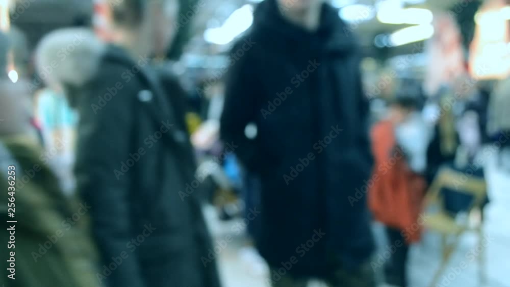 Many people walk inside the mall or store with illumination. Many people walk inside the mall or store with illumination.