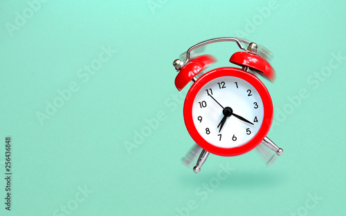 Ringing and bouncing red alarm clock background photo