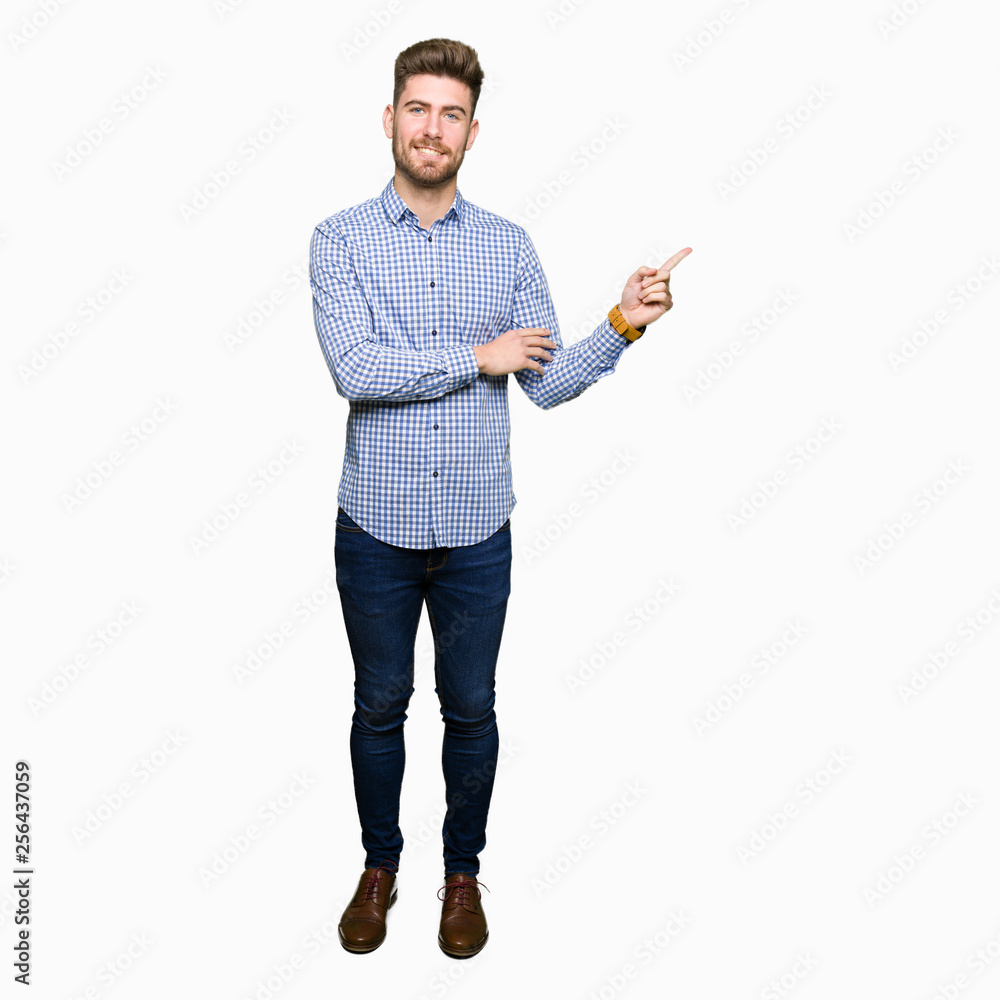 Young handsome bussines man with a big smile on face, pointing with hand and finger to the side looking at the camera. Young handsome bussines man with a big smile on face, pointing with hand and finger to the side looking at the camera.