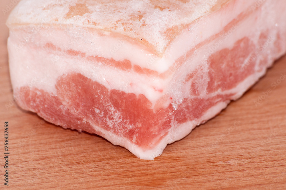 Frozen pork belly macro closeup on cutting board
