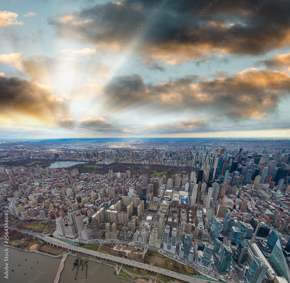 Wide angle aerial view of Midtown Manhattan and Central Park from helicopter at sunset, New York City