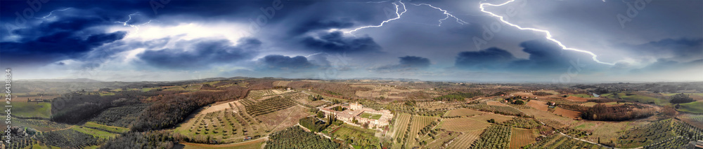 Fototapeta premium Amazing panoramic aerial view of Pontignano Charterhouse near Siena with storm approaching, Tuscany