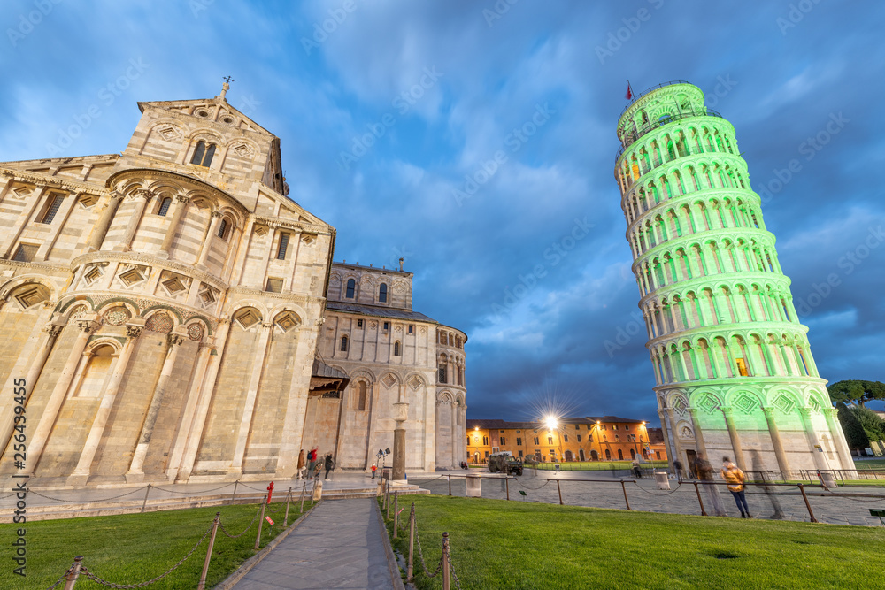 Pisa Tower and Cathedral in Miracles Square for St Patrick's Day illuminated by green lights, Tuscany - Italy