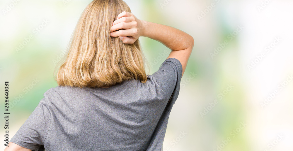 Beautiful young woman wearing oversize casual t-shirt over isolated background Backwards thinking about doubt with hand on head Beautiful young woman wearing oversize casual t-shirt over isolated background Backwards thinking about doubt with hand on head