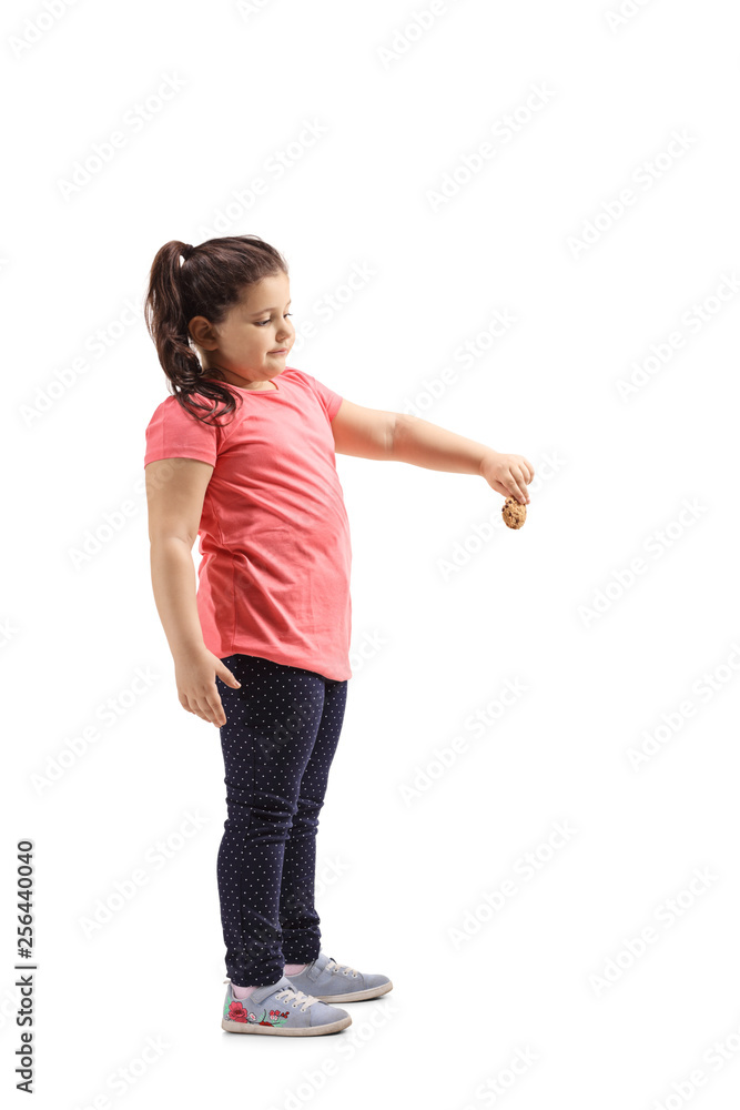 Little girl holding a biscuit and looking down Little girl holding a biscuit and looking down