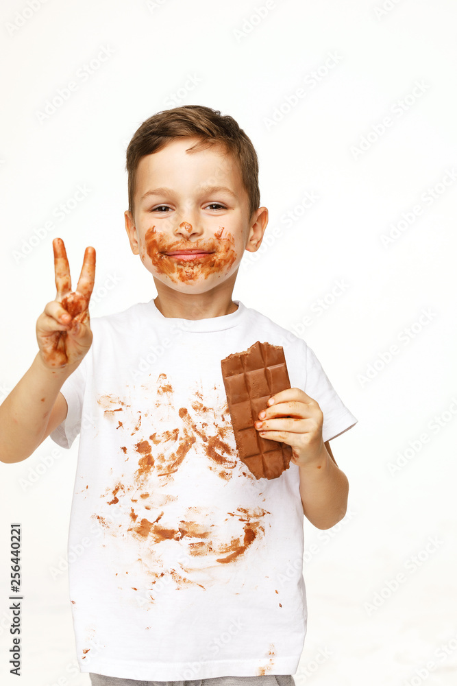 little boy with face and hands in chocolate little boy with face and hands in chocolate