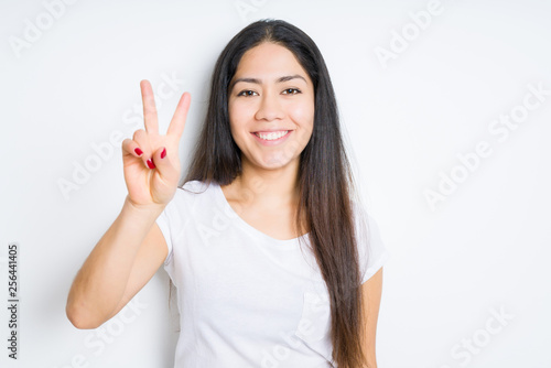 Wallpaper Mural Beautiful brunette woman over isolated background smiling with happy face winking at the camera doing victory sign. Number two. Torontodigital.ca