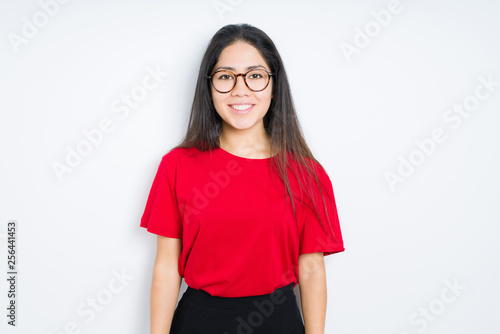 Beautiful brunette woman wearing glasses over isolated background with a happy and cool smile on face. Lucky person.