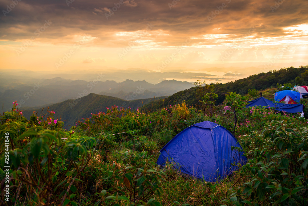 Mountain view with tourist tent. Sunset with beautiful clouds . Hiking concept, The adventure tourism. 