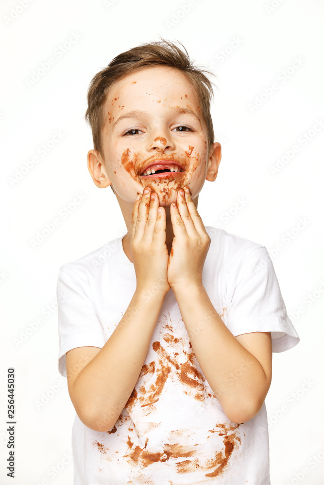 little boy with face and hands in chocolate little boy with face and hands in chocolate