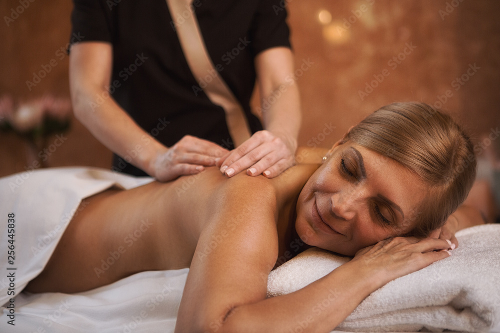 pence Bemyndigelse evne Mature woman getting massage at the spa Stock Photo | Adobe Stock