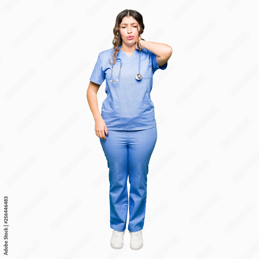 Young adult doctor woman wearing medical uniform Suffering of neck ache injury, touching neck with hand, muscular pain Young adult doctor woman wearing medical uniform Suffering of neck ache injury, touching neck with hand, muscular pain