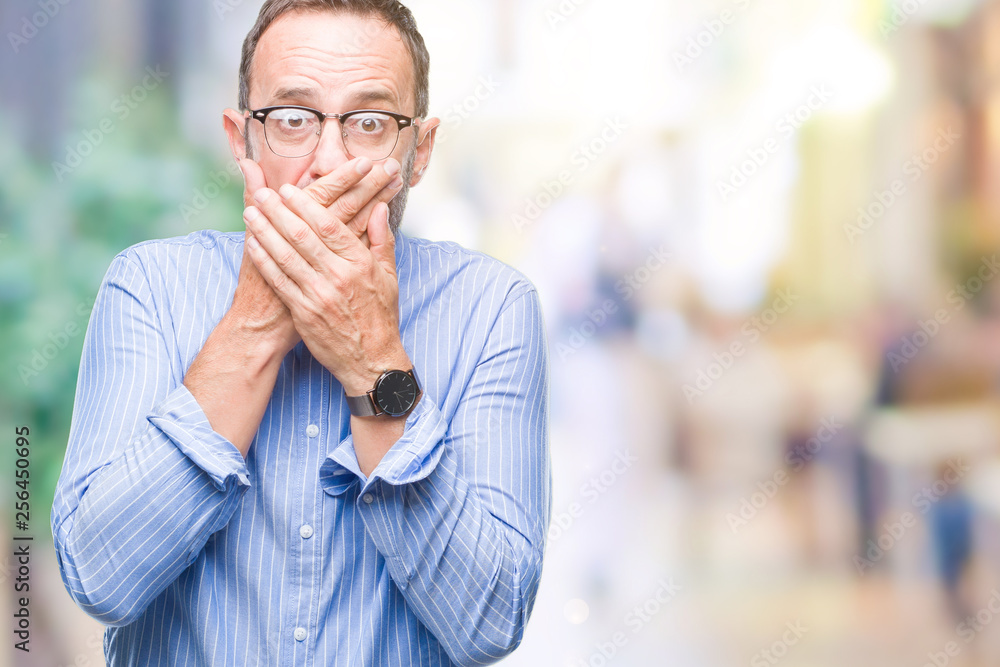 Middle age hoary senior man wearing glasses over isolated background shocked covering mouth with hands for mistake. Secret concept. Middle age hoary senior man wearing glasses over isolated background shocked covering mouth with hands for mistake. Secret concept.