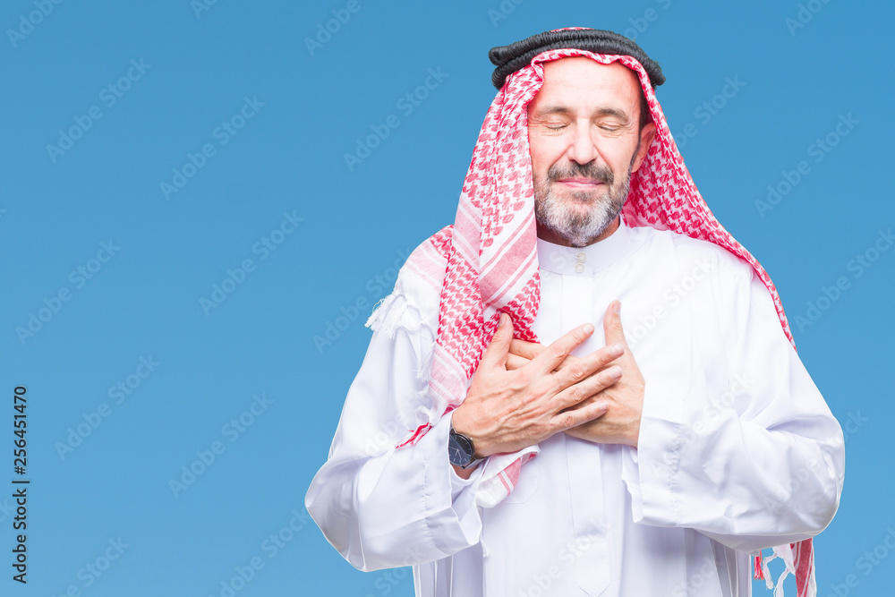 Senior arab man wearing keffiyeh over isolated background smiling with hands on chest with closed eyes and grateful gesture on face. Health concept.