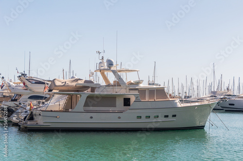 Fototapeta Naklejka Na Ścianę i Meble -  Tight marine yacht parking in calm water on bright sunny day