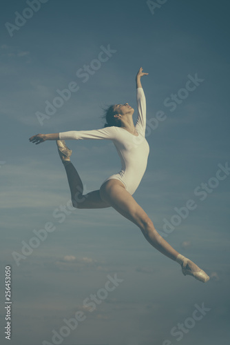 Grace in every move. Practicing art of classical ballet. Ballerina jumping on blue sky. Cute ballet dancer. Pretty woman in dance wear. Ballet class. Classic dance style. Concert performance dance