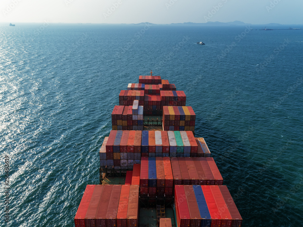 Fototapeta premium Aerial view container ship on the sea delivery container for logistics, import export, shipping or transportation.