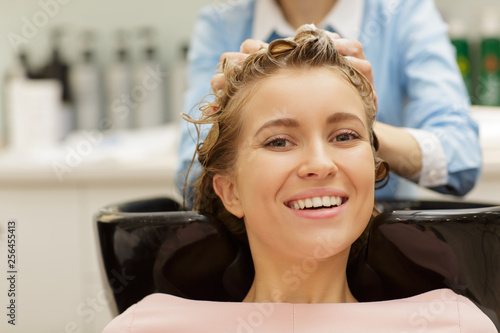 Gorgeous woman getting her hair washed at the salon