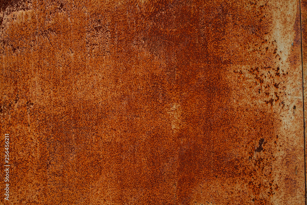 Rusty yellow-red textured metal surface. The texture of the metal sheet is prone to oxidation and corrosion. Textured background in grunge Style Rusty yellow-red textured metal surface. The texture of the metal sheet is prone to oxidation and corrosion. Textured background in grunge Style