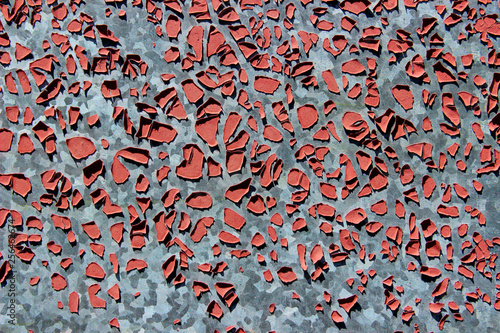 Old Red  Paint On A Gray Metal Wall. Abstract Background Texture. Old Cracked Paint On A Metal Surface. Cracked Paint. Wall Texture Grunge Background With A Lot Of Copy Space For Text.
