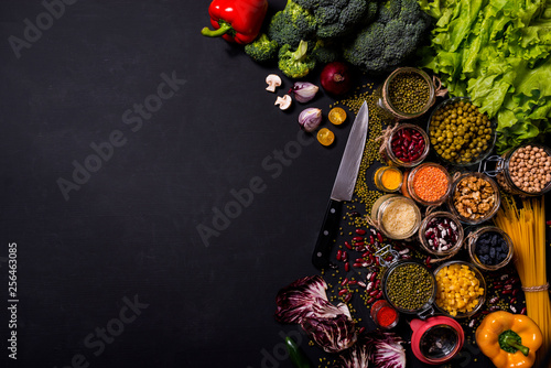 Trend set of fresh vegetables and fruits on black background. Different colorful fresh vegan food. Flat lay. Space for text.