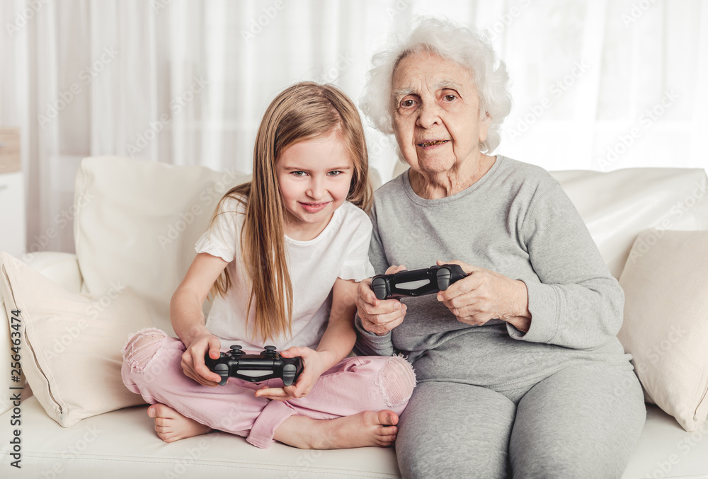 Grandmother with granddaughter playing games Grandmother with granddaughter playing games