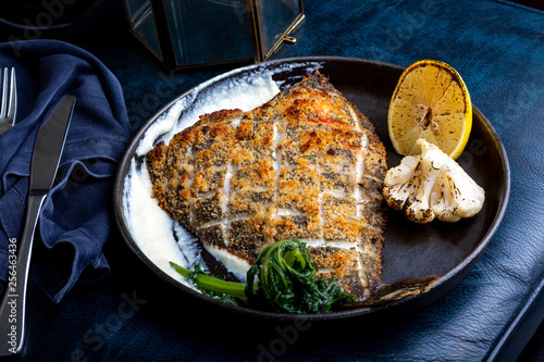 Fototapet Flounder fillet roasted in a skillet with herbs and lemon