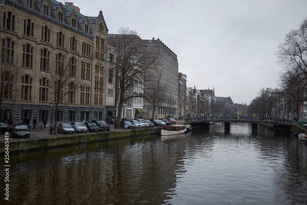 Amsterdam, Netherlands - February 22, 2019: View of a bridge over a canal