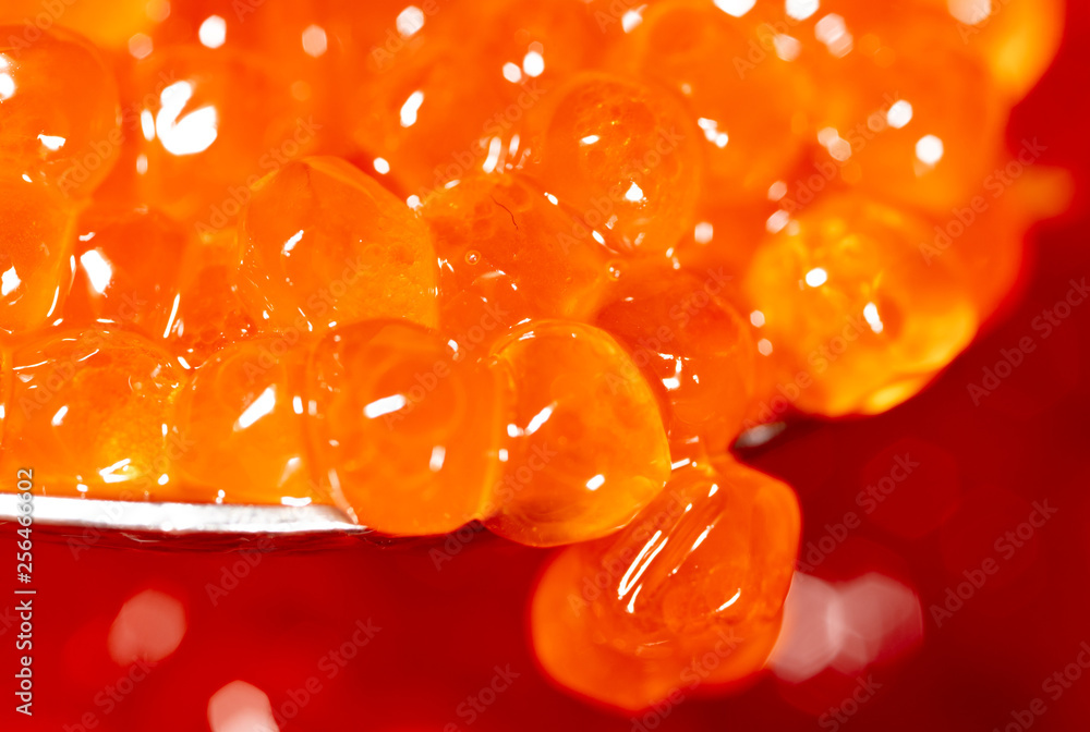 Red caviar on the spoon as a background Red caviar on the spoon as a background