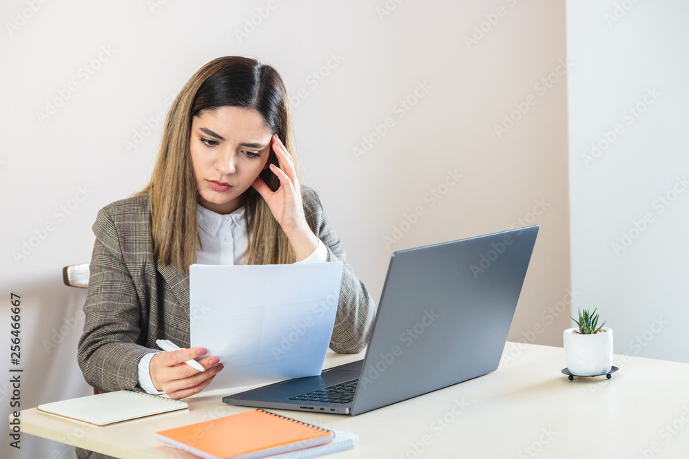 Beautiful young woman holding a paper, thinking and composing CV for a job apply Beautiful young woman holding a paper, thinking and composing CV for a job apply