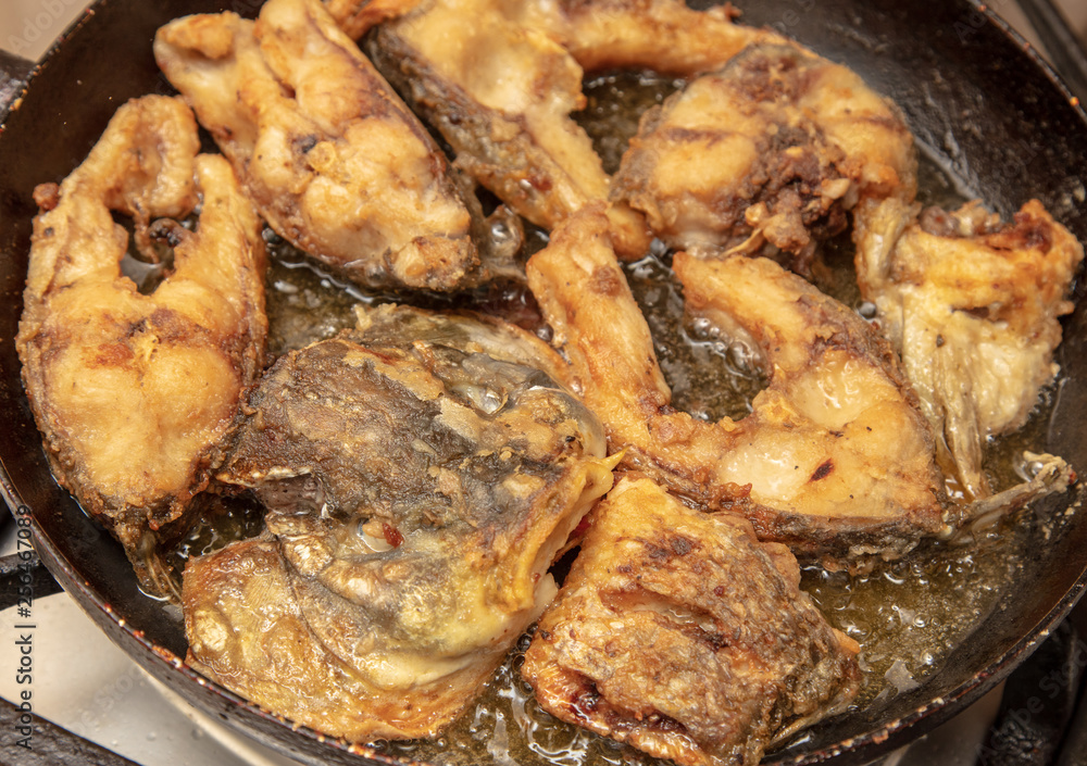 Fish is fried in a frying pan Fish is fried in a frying pan