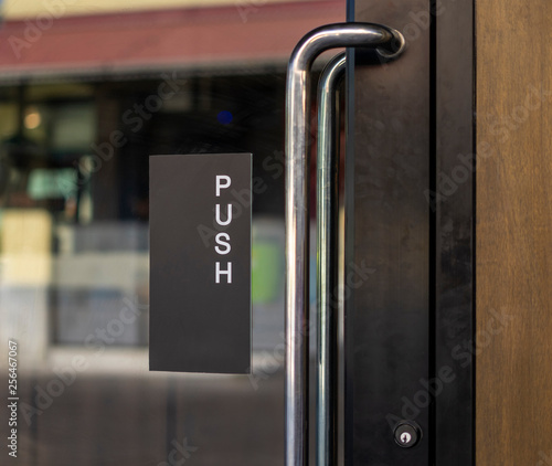Photography Restaurant door handle with push sign on glass doors
