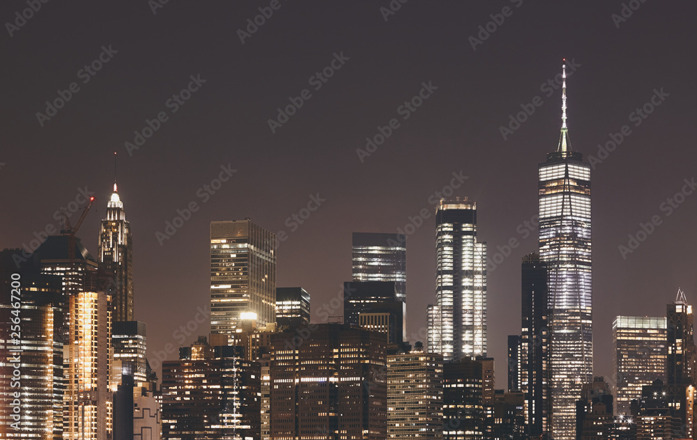 New York City skyline at night, color toning applied, USA.