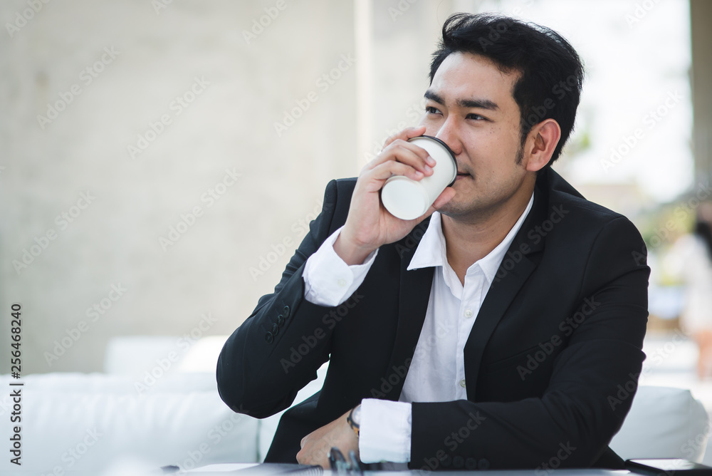 Asian businessman drinking coffee and work with laptop in cafe outside, lifestyle concept. Asian businessman drinking coffee and work with laptop in cafe outside, lifestyle concept.