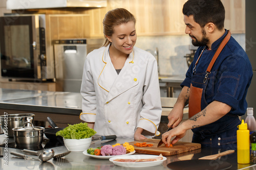 Professional chef and his assistant at the kitchen