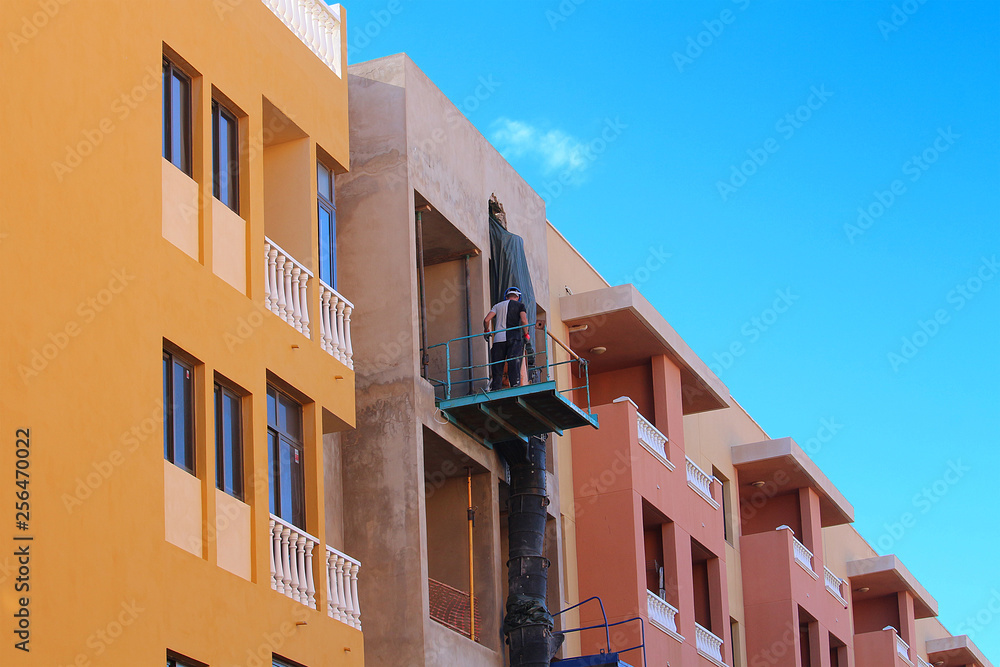 Worker at apartment building using a waste chute