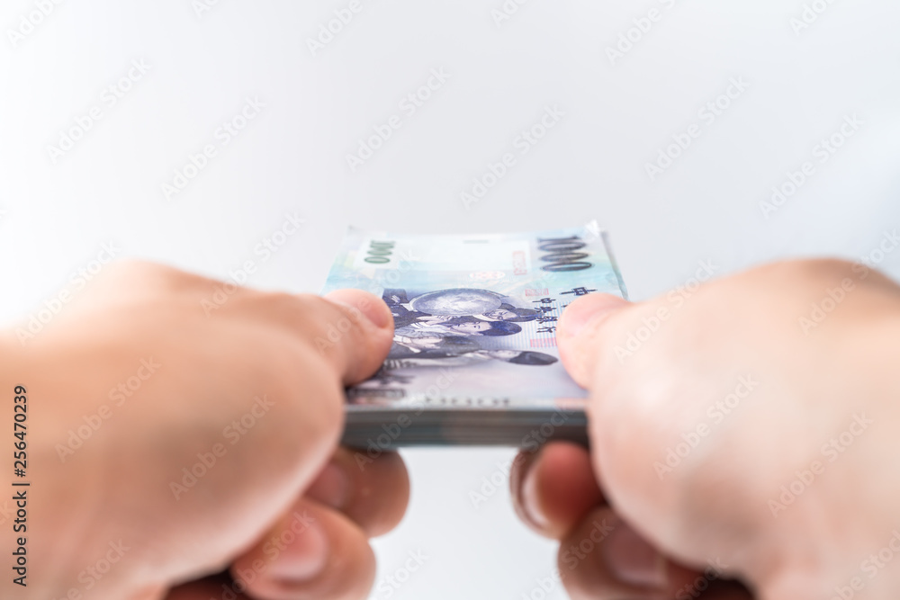 A hand holding a 1000 New Taiwan Dollar bill. A hand holding a 1000 New Taiwan Dollar bill.