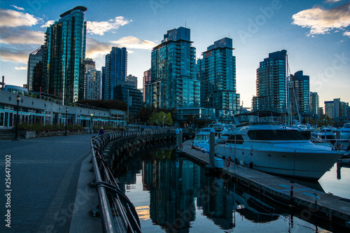 Quay of Vancouver. Sunset in the windows of building.