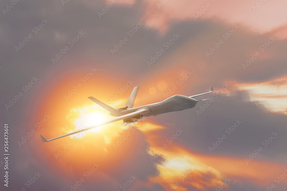 Military drone uav flying at sunset, the sun rays from the clouds.