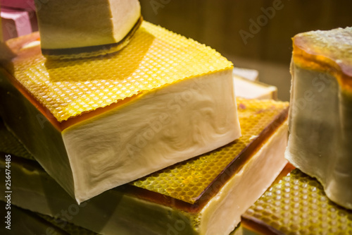 Fotografija In a show-window of shop pieces of soap of a different form and color, handmade