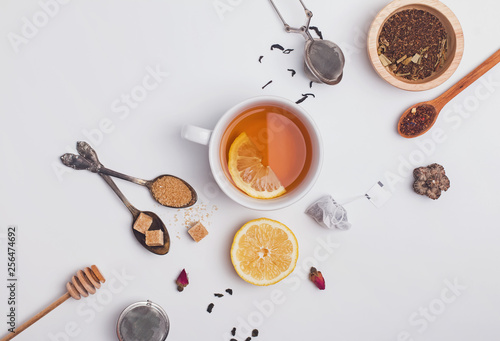 Fototapeta Creative composition witn variety of tea, sugar, lemon and other accessories for