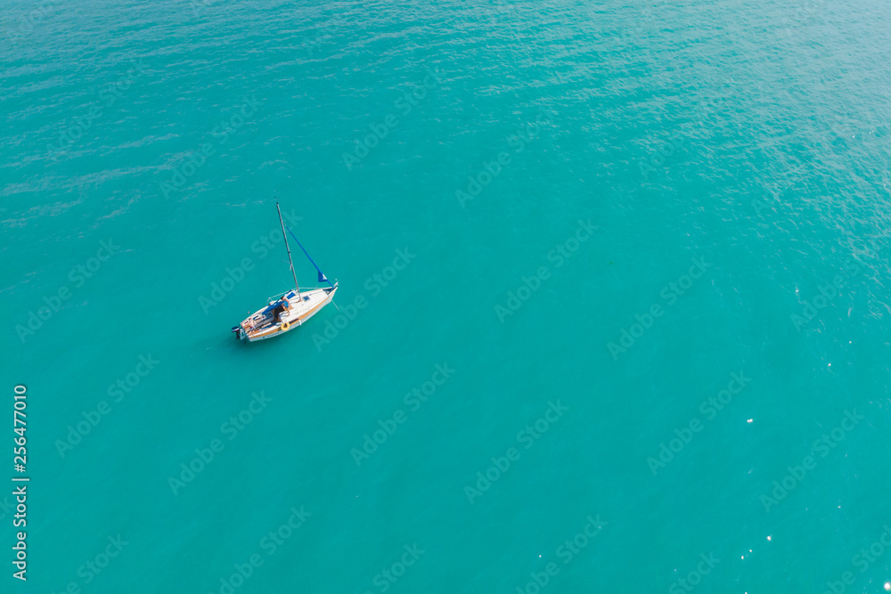 aerial view of boat in blue water aerial view of boat in blue water