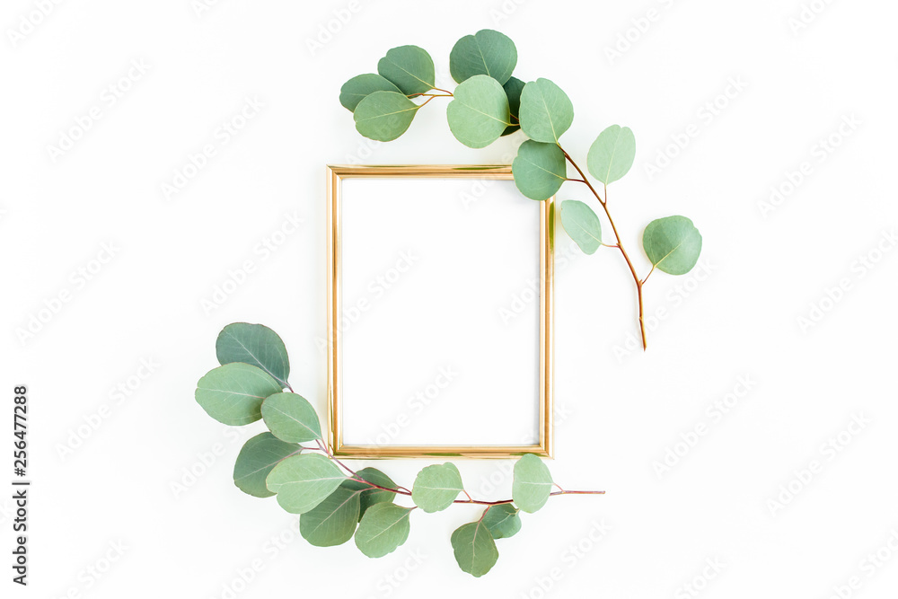 Gold frame is decorated with green branches and eucalyptus leaves on a ...