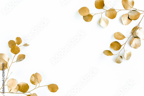 Borders of the frame of gold branches, eucalyptus leaves on a white background. flat layout, top view
