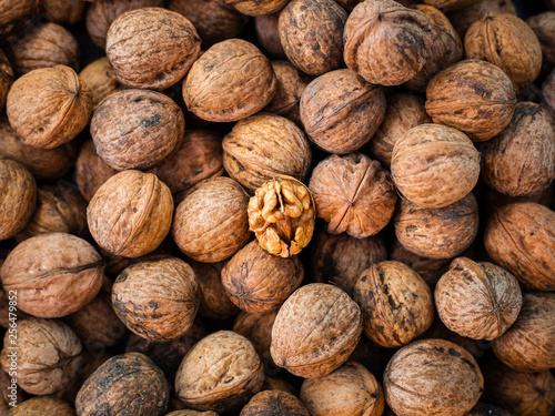 Walnut kernel on natural walnut pattern background, Raw bio walnuts texture, top view