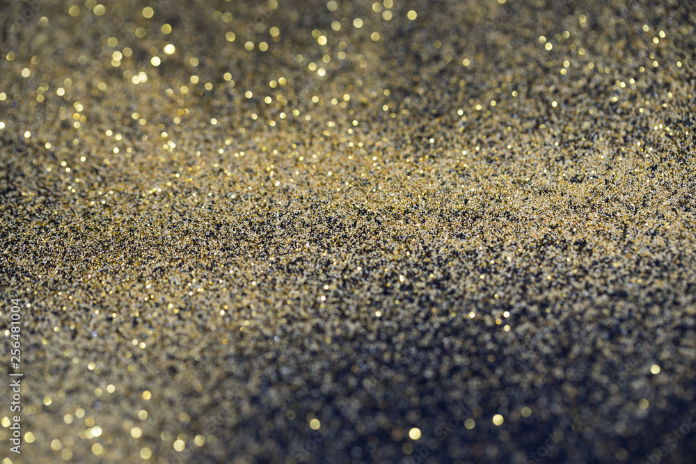 twinkling golden glitter falling on a flat surface lit by a bright spotlight (3d illustration) twinkling golden glitter falling on a flat surface lit by a bright spotlight (3d illustration)