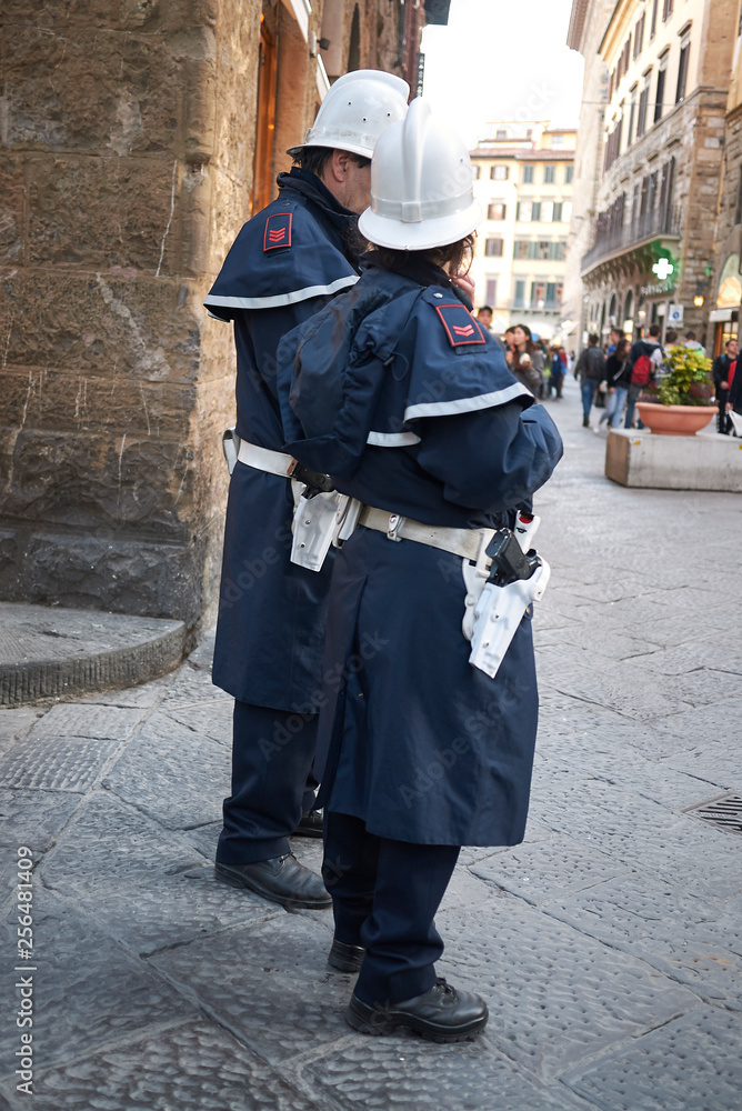 Florence, Italy - February 27, 2019 : Traffic poliman and policewoman in the street of Florence Florence, Italy - February 27, 2019 : Traffic poliman and policewoman in the street of Florence